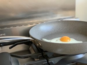 an egg being cooked in a frying pan